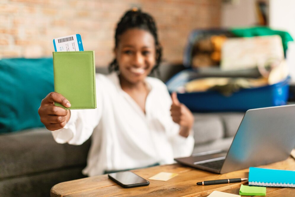 Happy Nigerian student holding an approved student visa and passport, ready to study abroad.