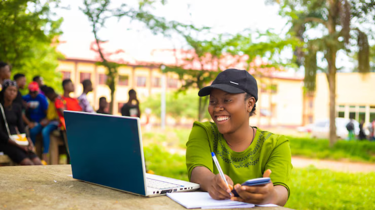 Happy Kenyan student holding a UK visa and a scholarship award letter, with UK university buildings in the background.